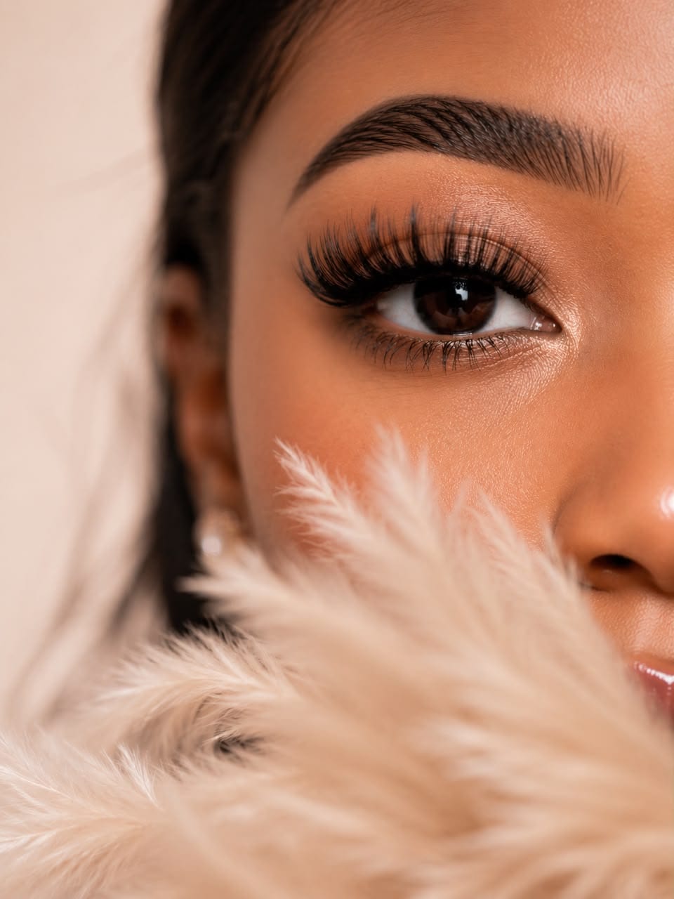 A finished lash set and shaped brow, photographed close up in the studio